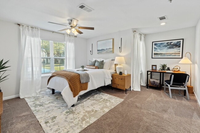 Bright Bedroom with Ample Natural Light and Ceiling Fan