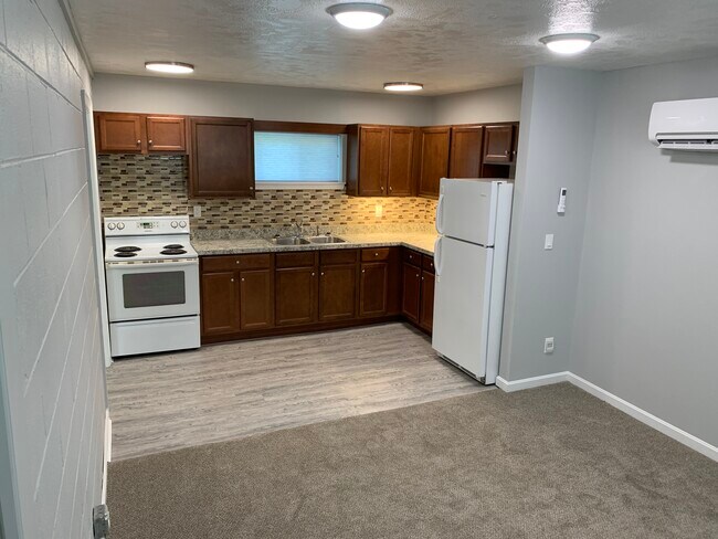 Kitchen with refigerator & stove - 705 Peach Tree Ln Unit Apt #1