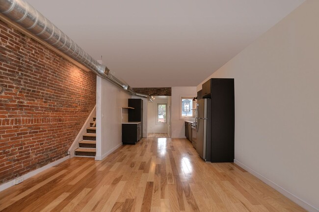 Living room looking back to kitchen/den - 1715 Locust St Apartments Unit 2