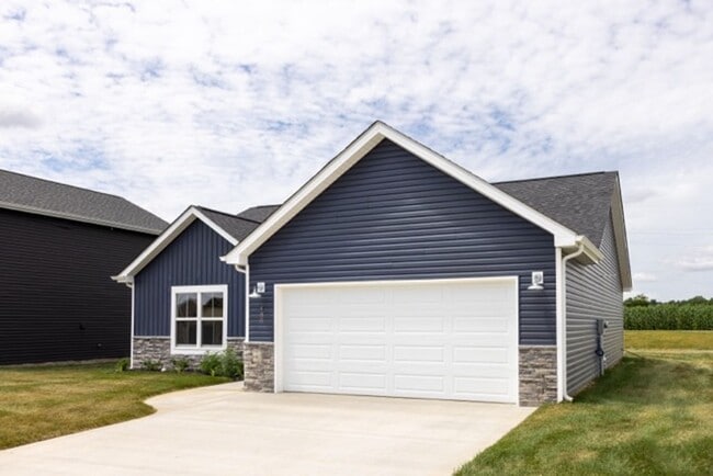 Photo - Modern Living Redefined with Stone Fireplace, Gray Cabinetry, Spa Inspired Primary Suite and Cove...