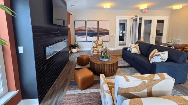 Clubhouse lounge area with seating, television, and fireplace at Greenwood Commons in Delaware, OH.