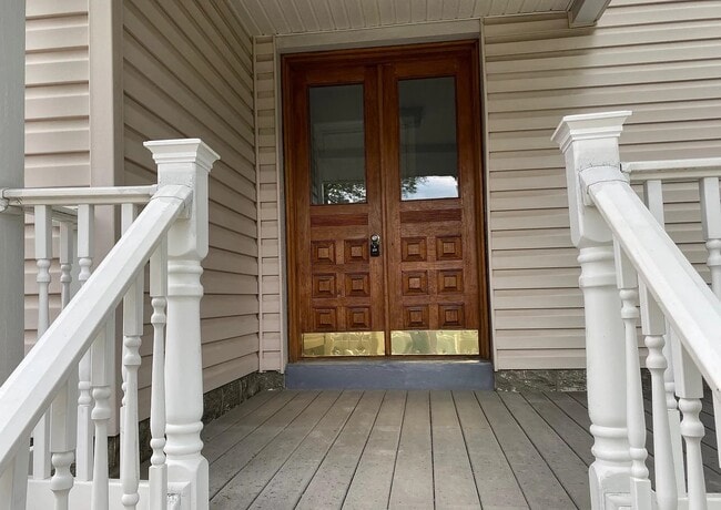 Welcoming front entrance featuring beautiful solid wood double doors and a covered porch. - 453 Lancaster Ave Unit 2