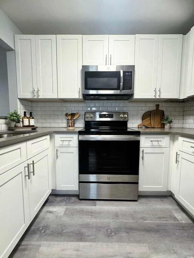 Modern Kitchen with Stainless-Steel Appliances, Quartz Countertops & Subway Tile Backsplash