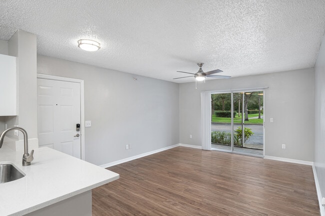 Spacious living room with ample natural light - Pine Lakes Preserve