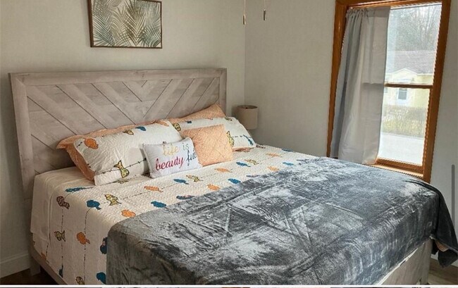 First floor bedroom with king bed seen in the picture. Bed not included as the house is unfurnished. - 22 Holt Rd