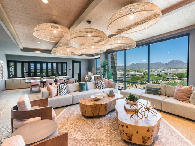 Relax, socialize, or unwind in the expansive resident lounge with curated textures, ample seating, and a warm, modern design. - Modera Scottsdale