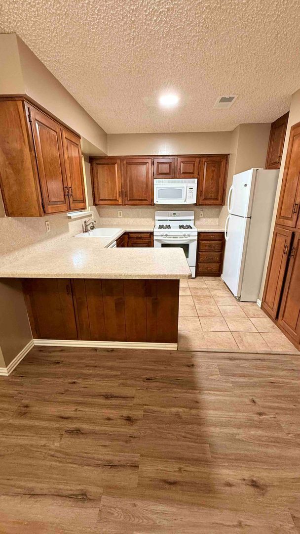 Photo - 3 bedroom / 2 bath / 2 car garage - Covered porch with shaded back yard