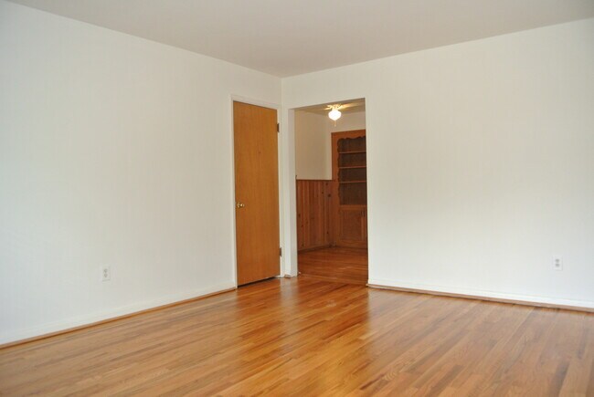 living room view into dining/desk area - 2935 Linwood Ave Apartments Unit #D