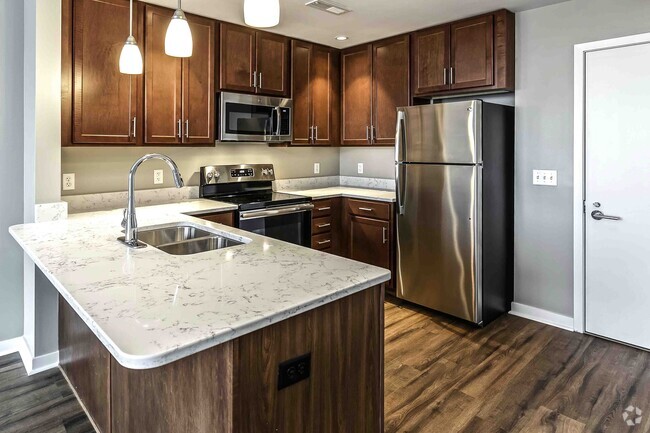 Our kitchens offer a functional design with ample cabinetry and counter space, making meal prep and organization effortless. - Midtown Crossing Apartments