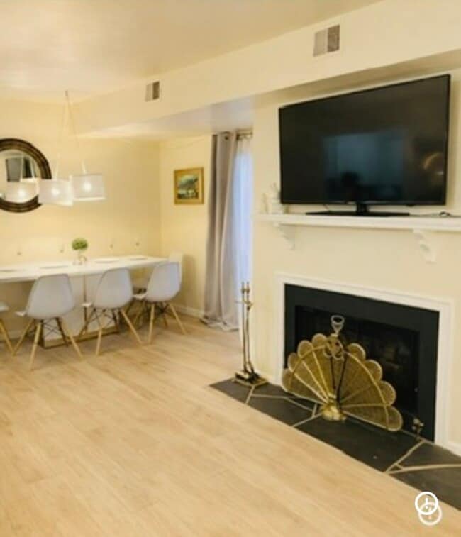 Living & Dining — Bright open space with wood-burning fireplace, modern lighting, and cozy dining - 3606 Timberline Trl Unit 2b/2bath