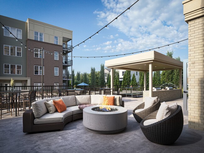 Outdoor lounge with a fire pit, pergola, and comfortable seating near Wasson Way.