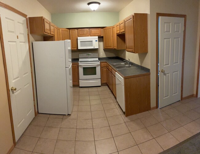 Kitchen featuring modern appliances including dishwasher - 401 Olmstead St Apartments Unit 4