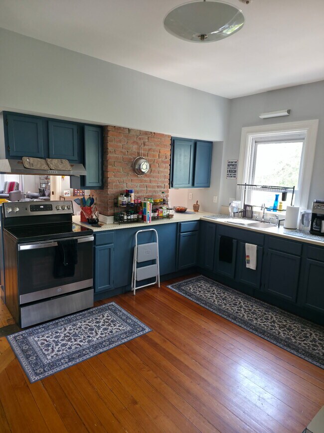 Kitchen stove and sink area - 86 Holden St Unit 2