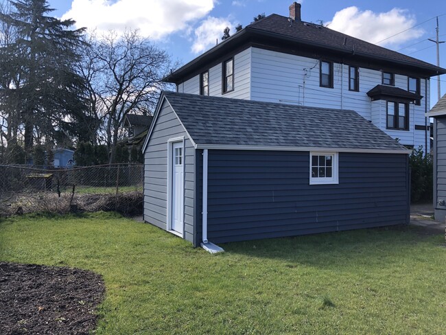 Outdoor storage for bikes, etc. is provided for both units in the garage. The garage is divided on the interior to create two separate storage areas and access for the studio-dedicated storage is through the rear, lockable, door. - 4842 NE Mallory Ave Townhome