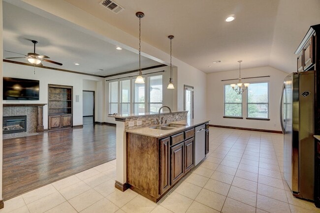 Photo - Stunning 4-Bedroom Home with Fireplace, Island Kitchen, 3-Car Garage & Large Backyard!