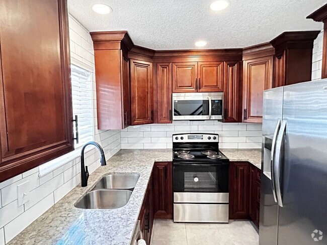 Building Photo - Newly Renovated 2/1.5 Condo in Gated Commu...