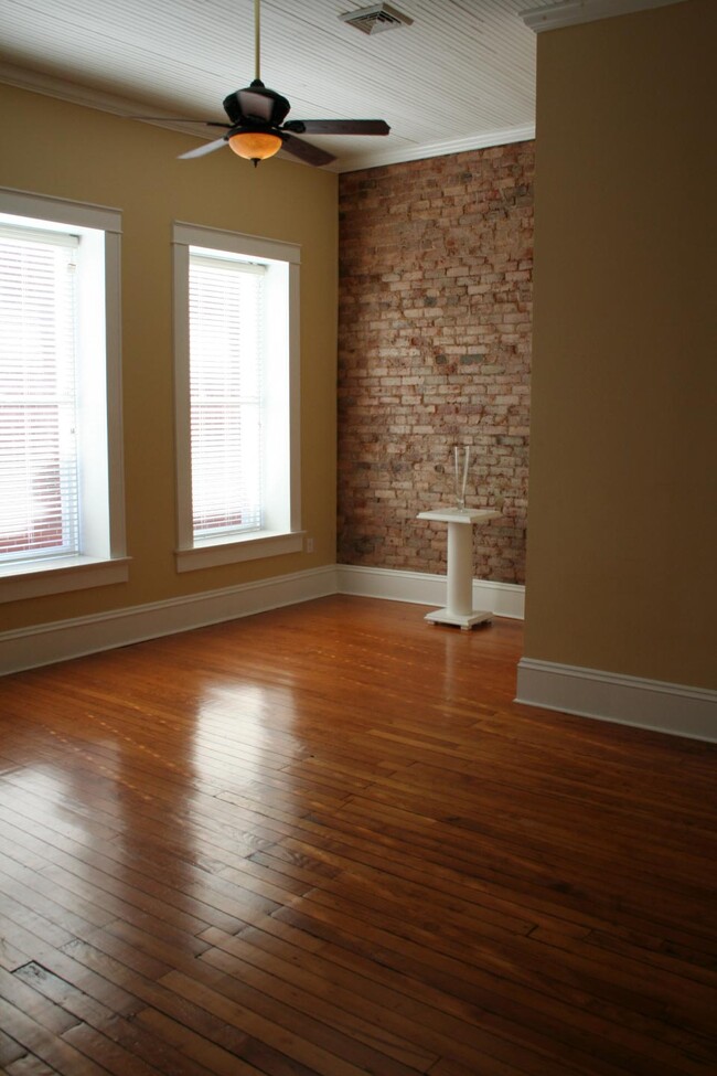 exposed brick walls in living and bedrooms - 117 E Innes St Apartments Unit 117-B E Innes St