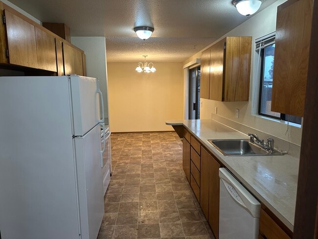 kitchen with fridge freezer, oven and dishwasher - 6439 Armar Rd Unit # 2