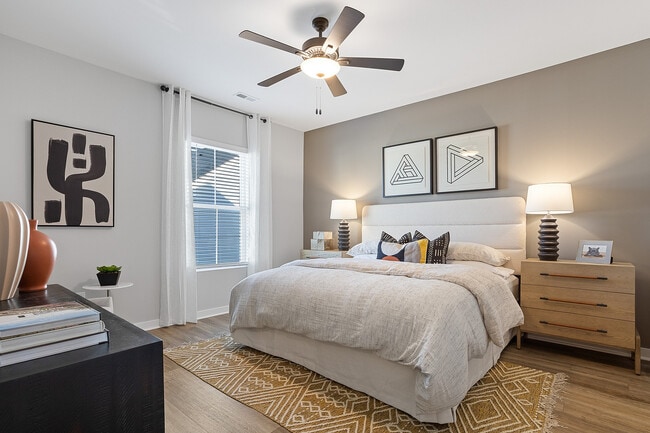 Large Primary Bedroom with Ceiling Fan and Wood Style Flooring