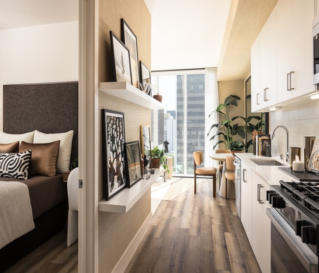Chic urban apartment with cozy bedroom, modern kitchen, and stylish dining nook overlooking the city.