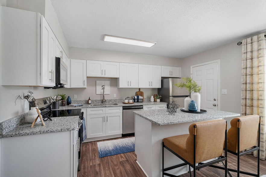 Kitchen with granite counters, stainless appliances, and modern cabinetry