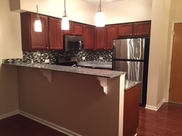 New paint, backsplash and lighting in kitchen - 405 S Creekside Dr Unit 204