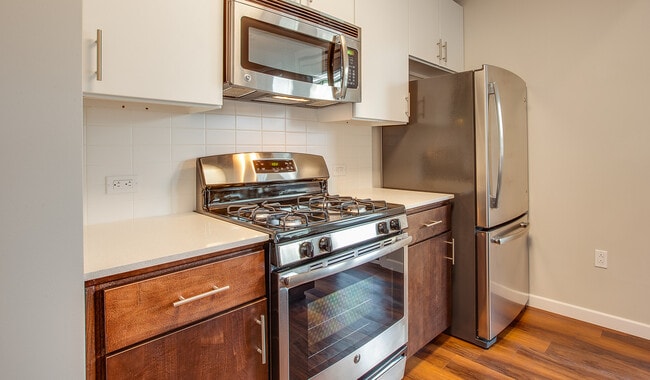 Spacious kitchens with wood flooring throughout