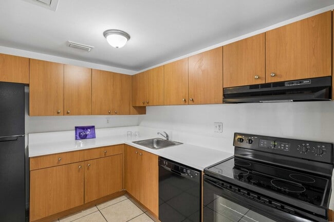 Elevate your lifestyle at Clear Lake Palms Apartments with this modern kitchen featuring sleek appliances and ample cabinetry. Perfect for culinary creations, this space combines functionality and style. Schedule your tour today!