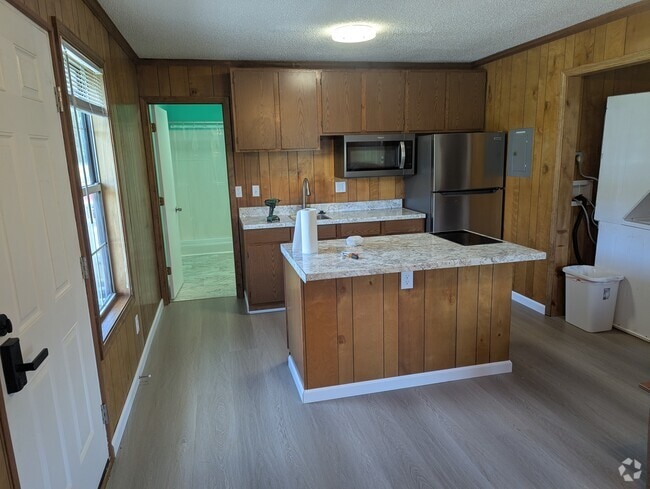 Kitchen with island, microwave, fridge, 2 burner stovetop. - 108 Business Park Cir Unit A1 Rental