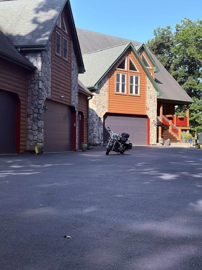 Front view. Rental apartment occupies the space above the 3 primary garages.