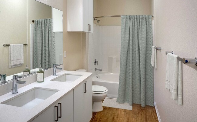 Renovated Package II bathroom featuring white cabinetry, white quartz countertops, and hard surface flooring