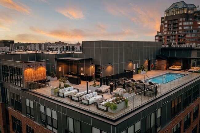 Rooftop lounge area featuring poolside seating and cabanas