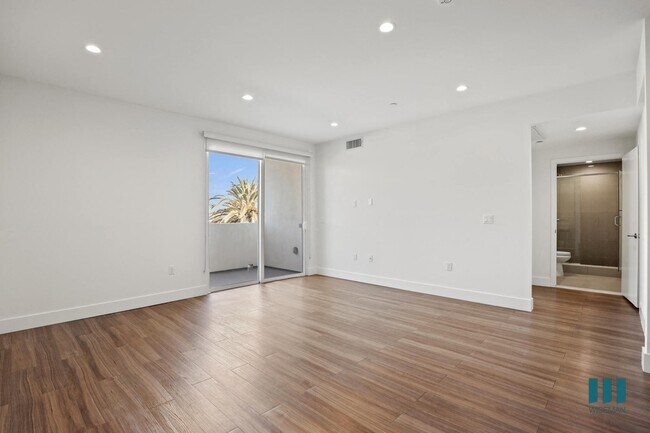 Living Room with Vinyl Flooring, Recessed Lighting, and Patio