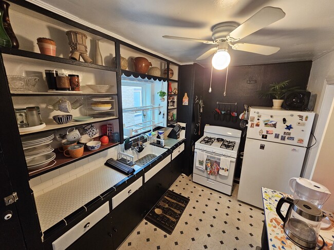 Kitchen has gas stove and full-size fridge. - 2506 Elmen St Unit 2A