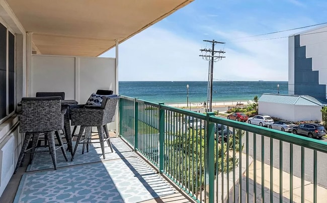 Large furnished balcony overlooking the ocean.