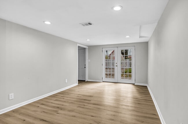 Living room flushed with natural light from French doors