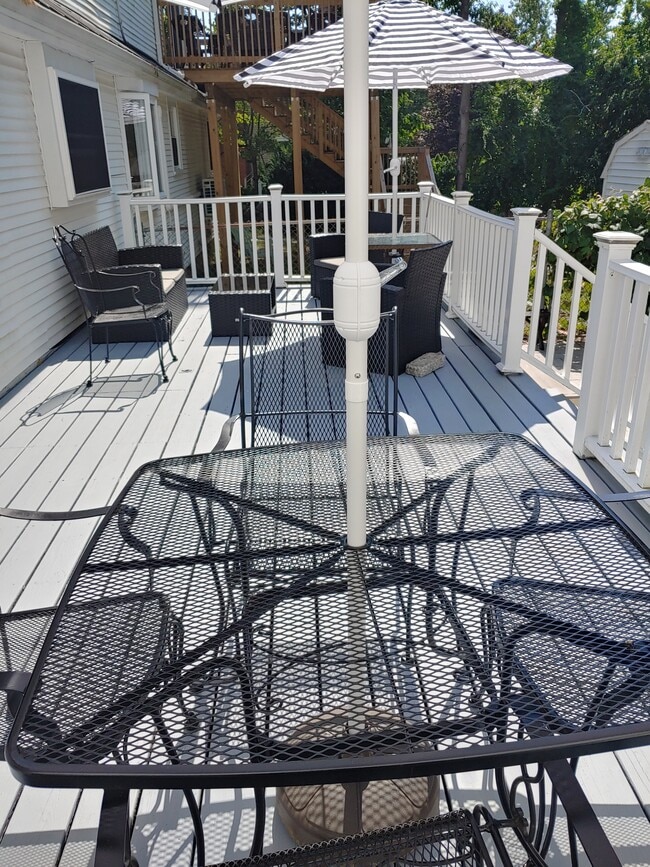 one of two decks and patio area fully furnished with stored pillows - 623 Old West Central St Unit 2 Bd Apt in 2 Family Home