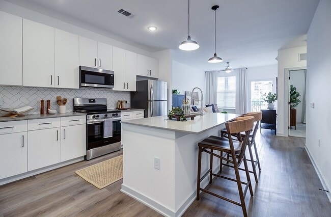 In The Mound one-bedroom, the kitchen island doubles as a breakfast bar and opens straight into the living room.