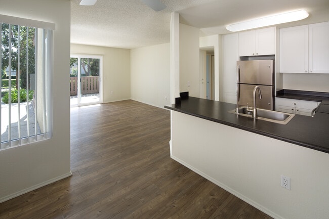 Renovated Package I kitchen, dining, and living area with hard-surface flooring