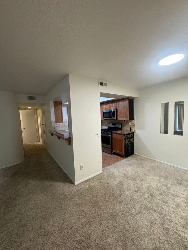 Hallway to bedrooms, kitchen, dining room - 9408 Twin Trails Dr Unit 106
