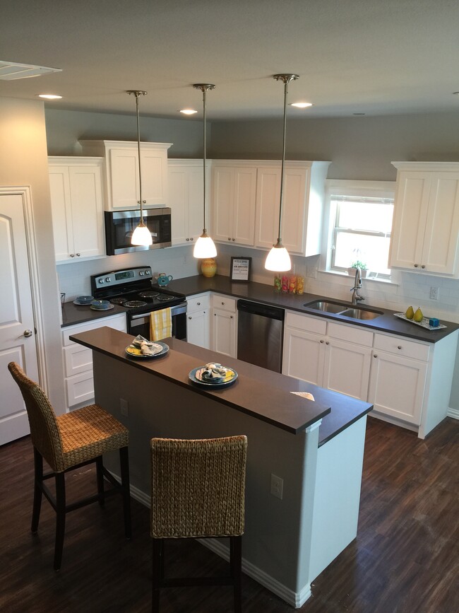 Kitchen with Pantry, Breakfast Bar, and Pendant Lighting - 4926 Villas Drive Casa Adosada