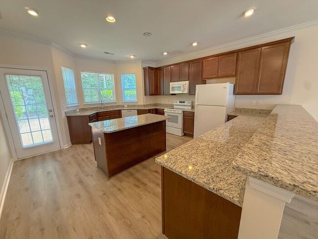 Photo - Beautifully updated Townhome! New cabinets, granite counter tops, and LVP flooring through downst...
