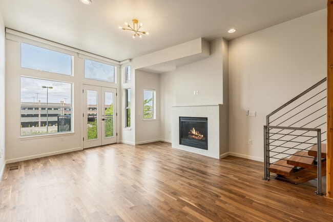 the living room features a gas fireplace & newly refinished floors - 2680 Blake St Townhome