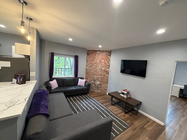 Living area with accent brick wall - 3932 Vinceton St.