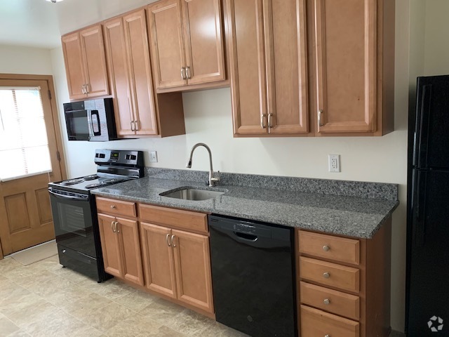 New kitchen with granite counter - Park Hill Apartments