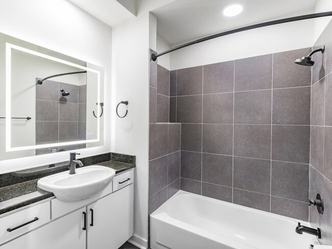Serene bathrooms featuring LED backlit mirrors.