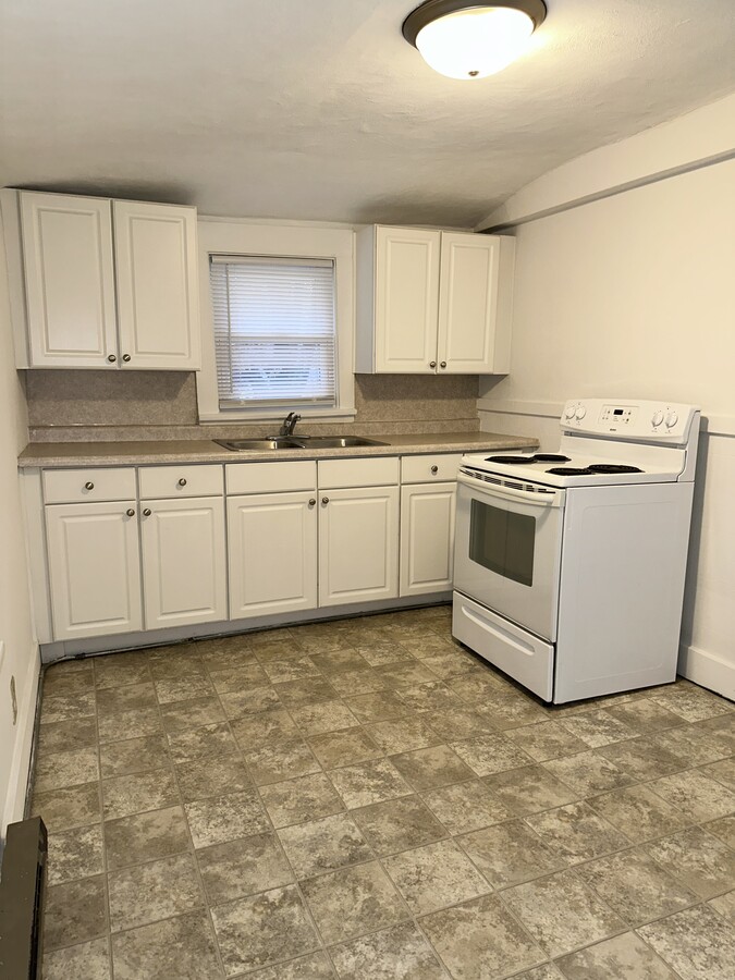 Large kitchen. Stove & Fridge/freezer provided. Plenty of room for a table. - 803 W Edwards St Apartments Unit C