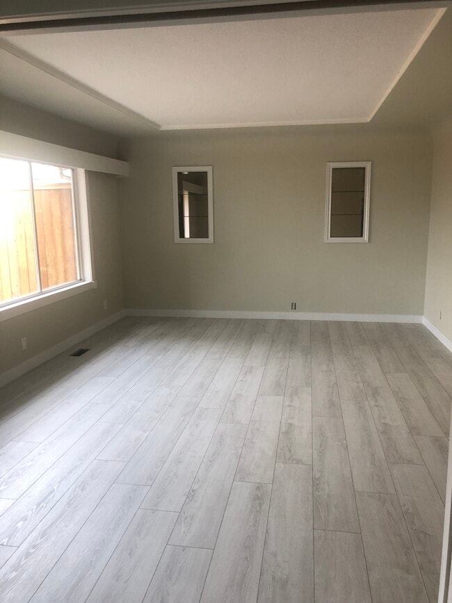 Large living room with updated flooring and paint - 11535 Millar Rd