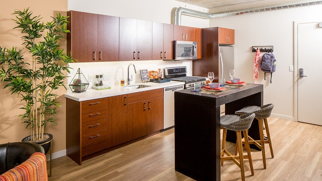 Modern kitchens outfitted with stainless steel appliances, and quartz countertops with tile backsplashes