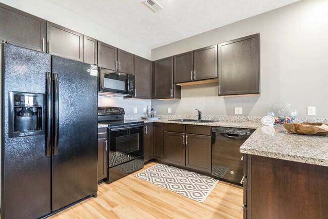 Our large kitchens feature granite countertops, modern hardware and ample storage. - The Flats at 84 Apartments